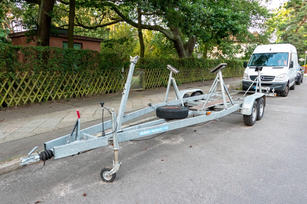 Transportation of a new boat, yacht on a car trailer, semitrailer. High quality photo